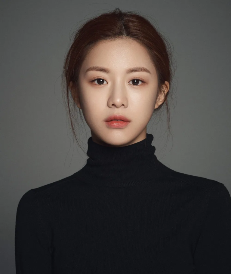 Headshot profile picture of South Korean actress Go Youn-jung posing in a black turtleneck sweater, highlighting her iconic visual features