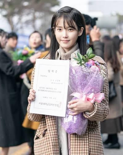 IU as Yang Geum-myeong holding an admission certificate in When Life Gives You Tangerines